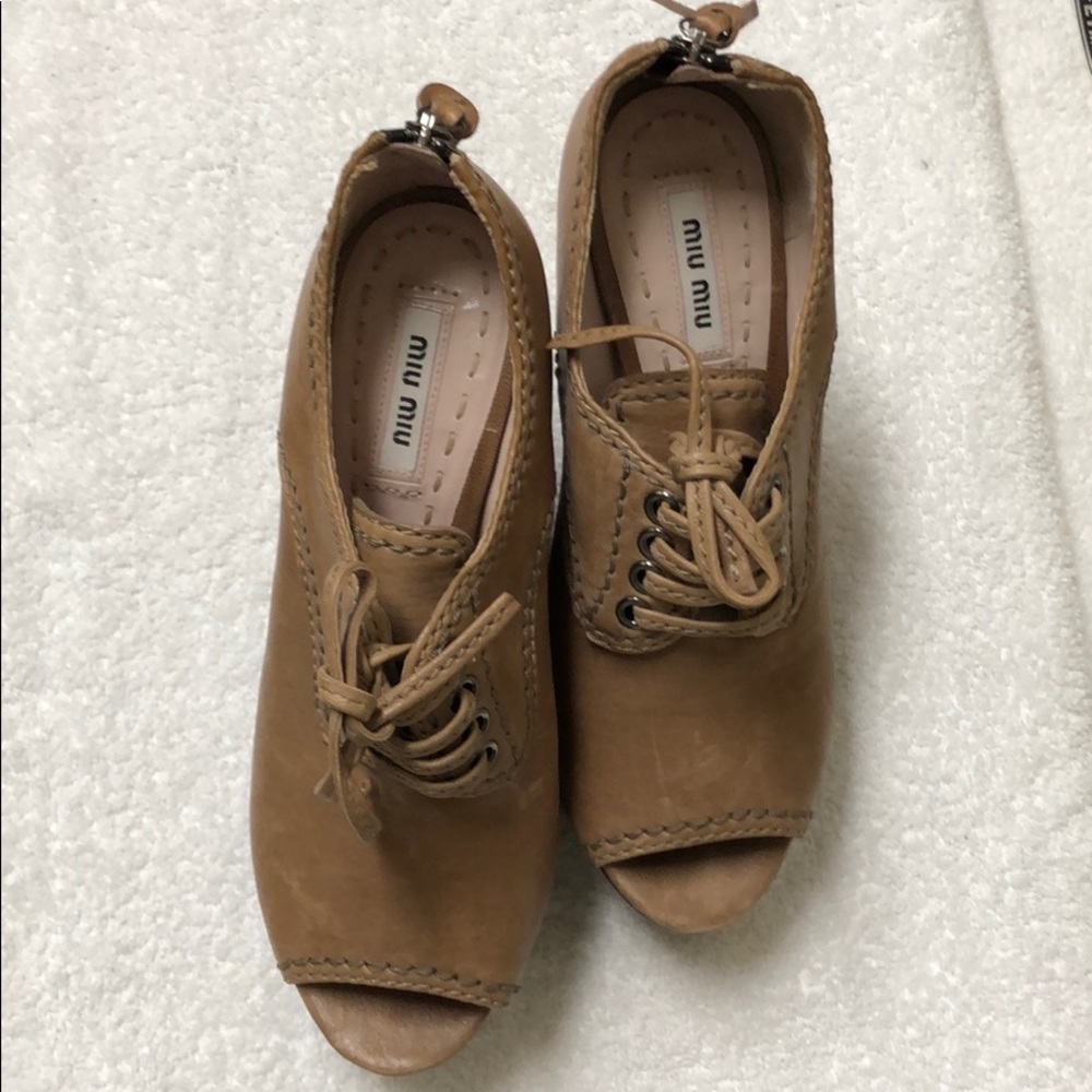 Miu Miu leather peep-toe zip back wedge bootie.